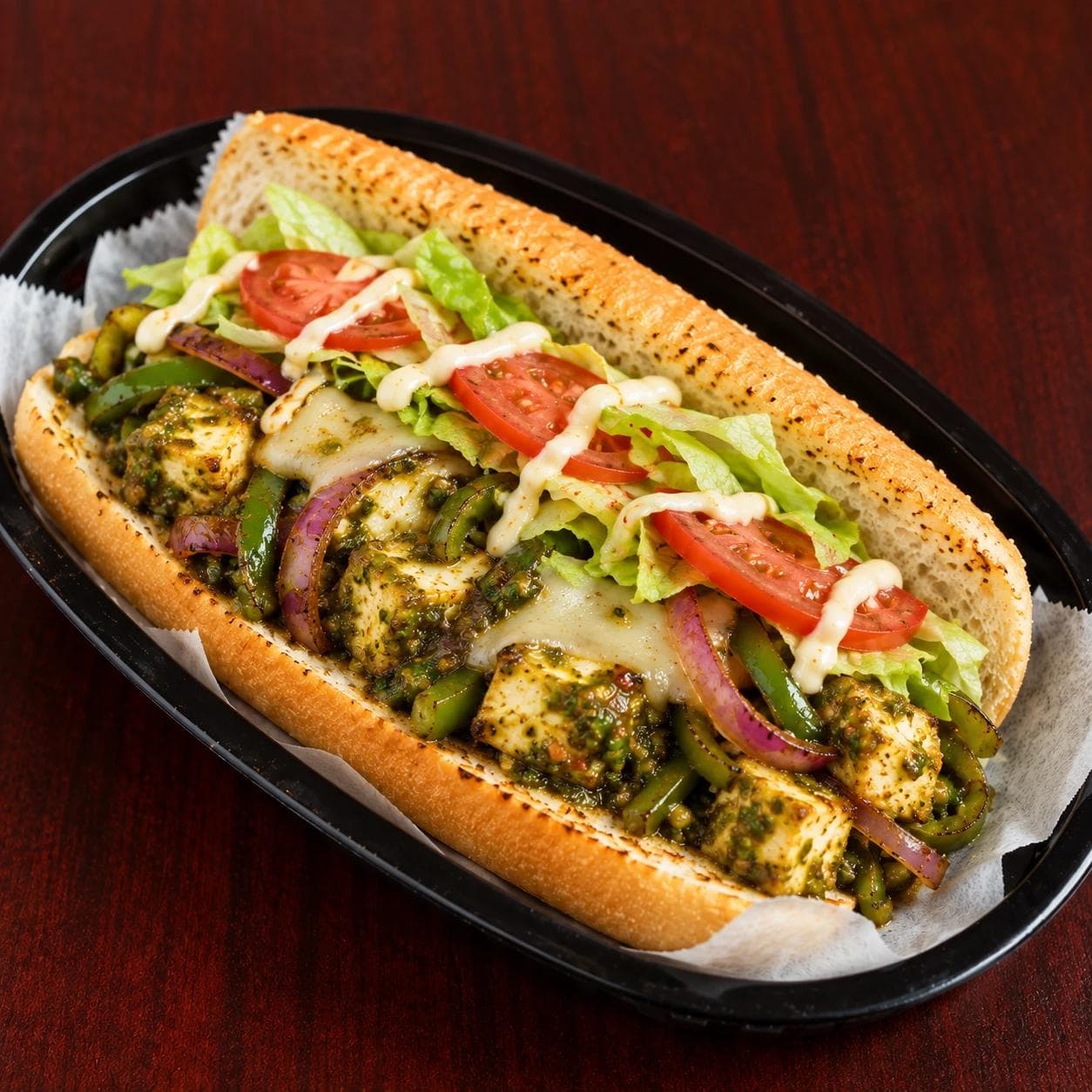 Chilli paneer with grilled peppers and onions, provolone, lettuce, tomatoes, and mayo.